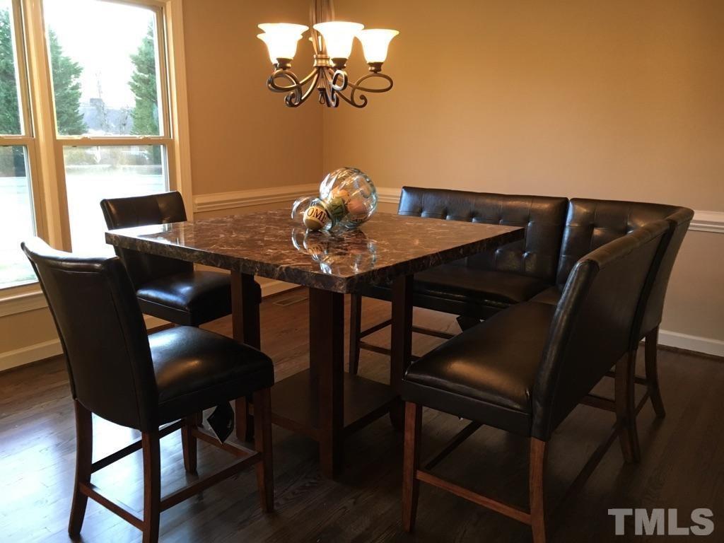 1608 Spennymore Road Raleigh, NC 27603 - Photo 17 of 25 a view of a dining room with furniture and window