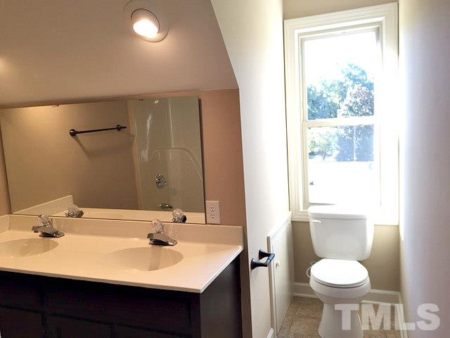 1608 Spennymore Road Raleigh, NC 27603 - Photo 25 of 25 a bathroom with a sink toilet and a mirror