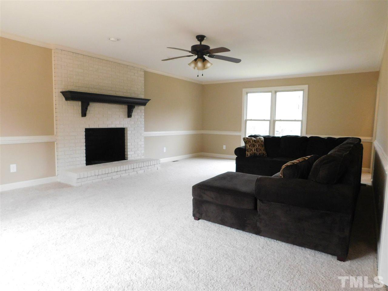 1608 Spennymore Road Raleigh, NC 27603 - Photo 7 of 25 a living room with furniture and a fireplace