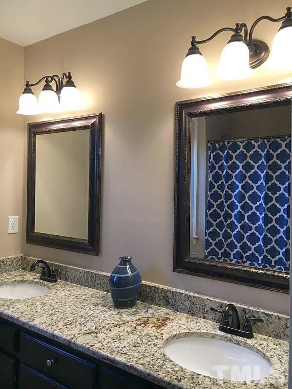 1608 Spennymore Road Raleigh, NC 27603 - Photo 10 of 25 a bathroom with a granite countertop sink and a mirror