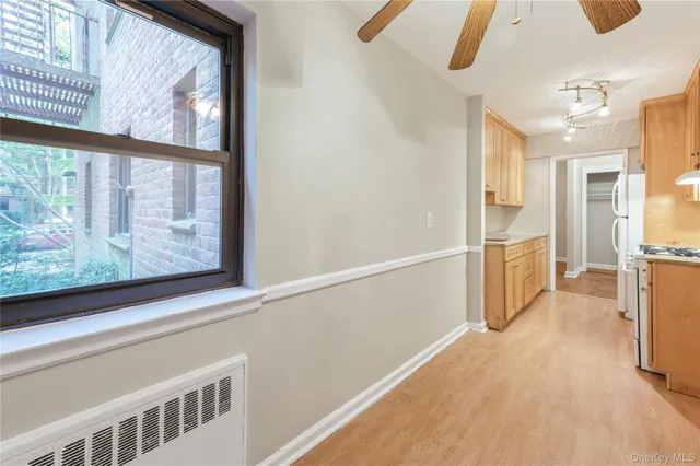 a view of a hallway with wooden floor and furniture