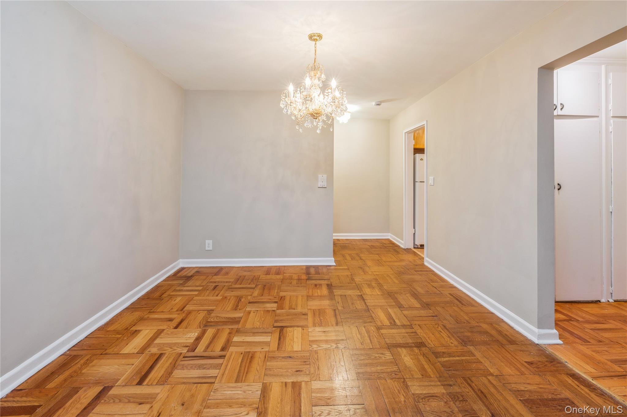 50 White Oak Street, Unit 1E New Rochelle, NY 10801 - Photo 7 of 19 a view of a room with a chandelier fan and wooden floor