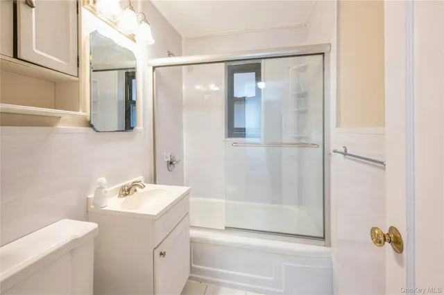 a bathroom with a shower sink and mirror