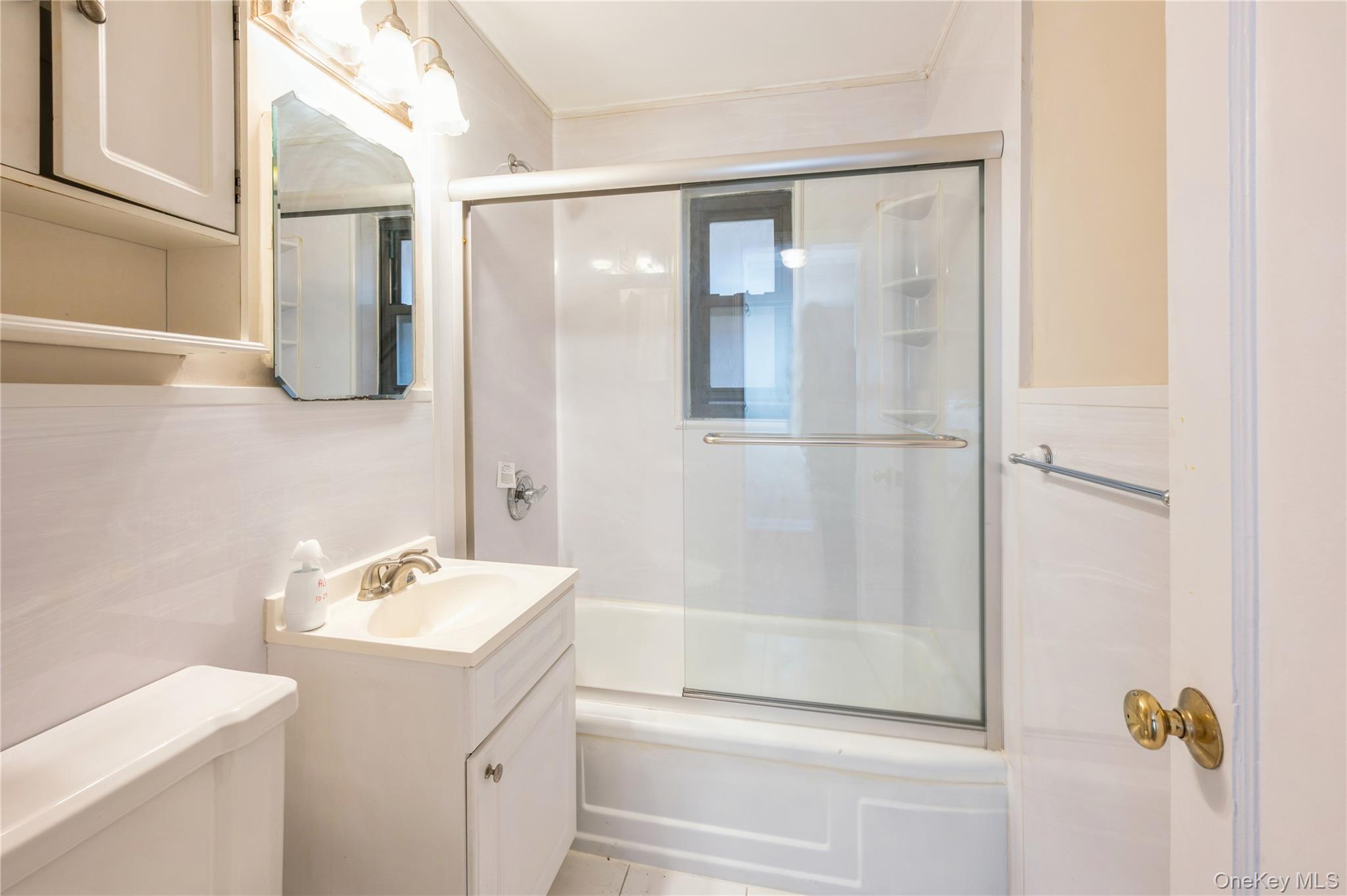 50 White Oak Street, Unit 1E New Rochelle, NY 10801 - Photo 10 of 19 a bathroom with a shower sink and mirror