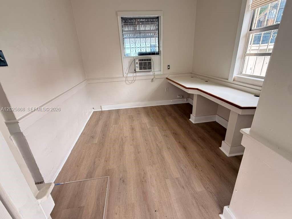 1919 Southwest 2nd Street, Unit B Miami, FL 33135 - Photo 2 of 12 wooden floor in an empty room with a window