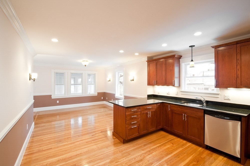 72 Bennett Street, Unit 72 Boston, MA 02135 - Photo 7 of 17 a large kitchen with stainless steel appliances granite countertop a sink and cabinets