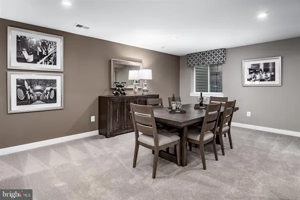 a dining room with furniture and window