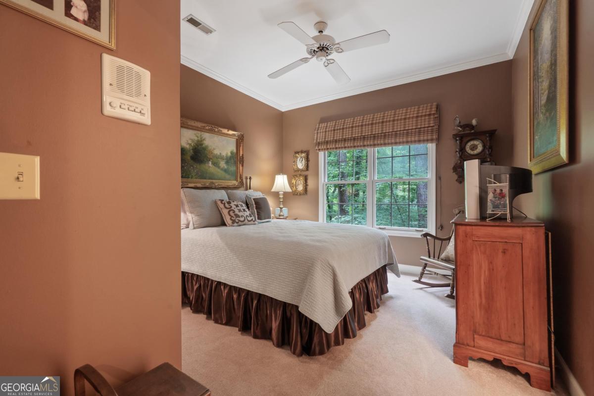 1031 Old Still Road Greensboro, GA 30642 - Photo 53 of 73 a bed sitting in a spacious bedroom next to a window