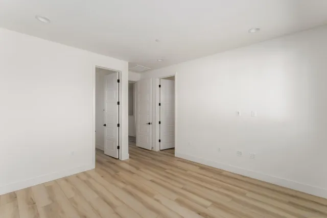 a view of an empty room with windows and outdoor view