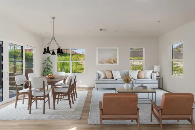 a kitchen with stainless steel appliances a stove top oven a sink a refrigerator white cabinets and wooden floor