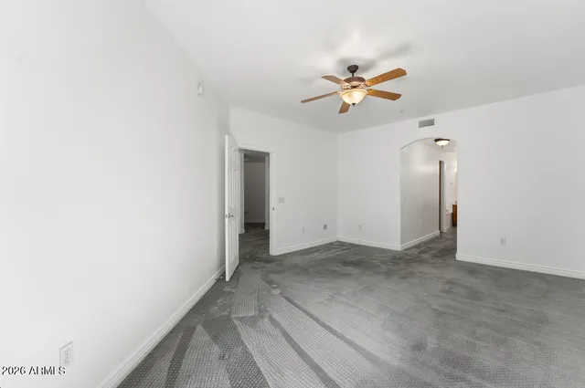 a view of room with a ceiling fan and window