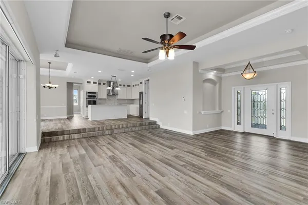 a view of a kitchen with a sink and wooden floor