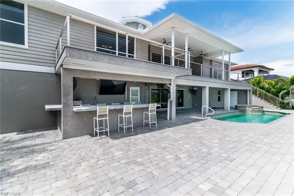 a view of a house with a patio and a yard