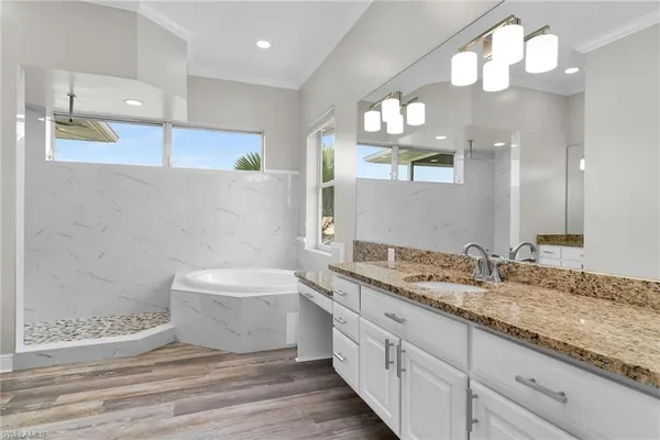 a bathroom with a sink a toilet and a large mirror