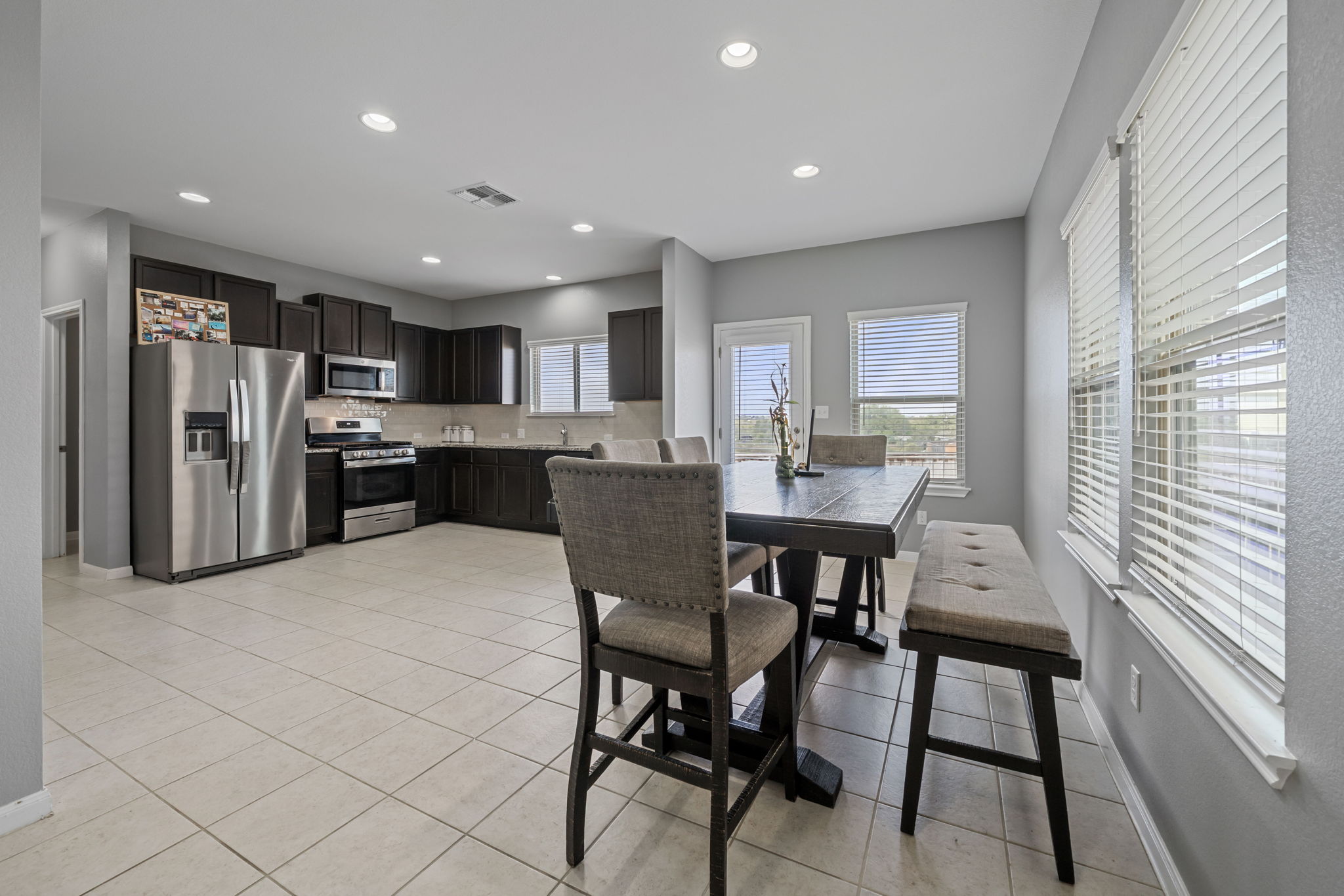 436 Spinnaker Loop Kyle, TX 78640 - Photo 2 of 14 a large kitchen with a table and chairs