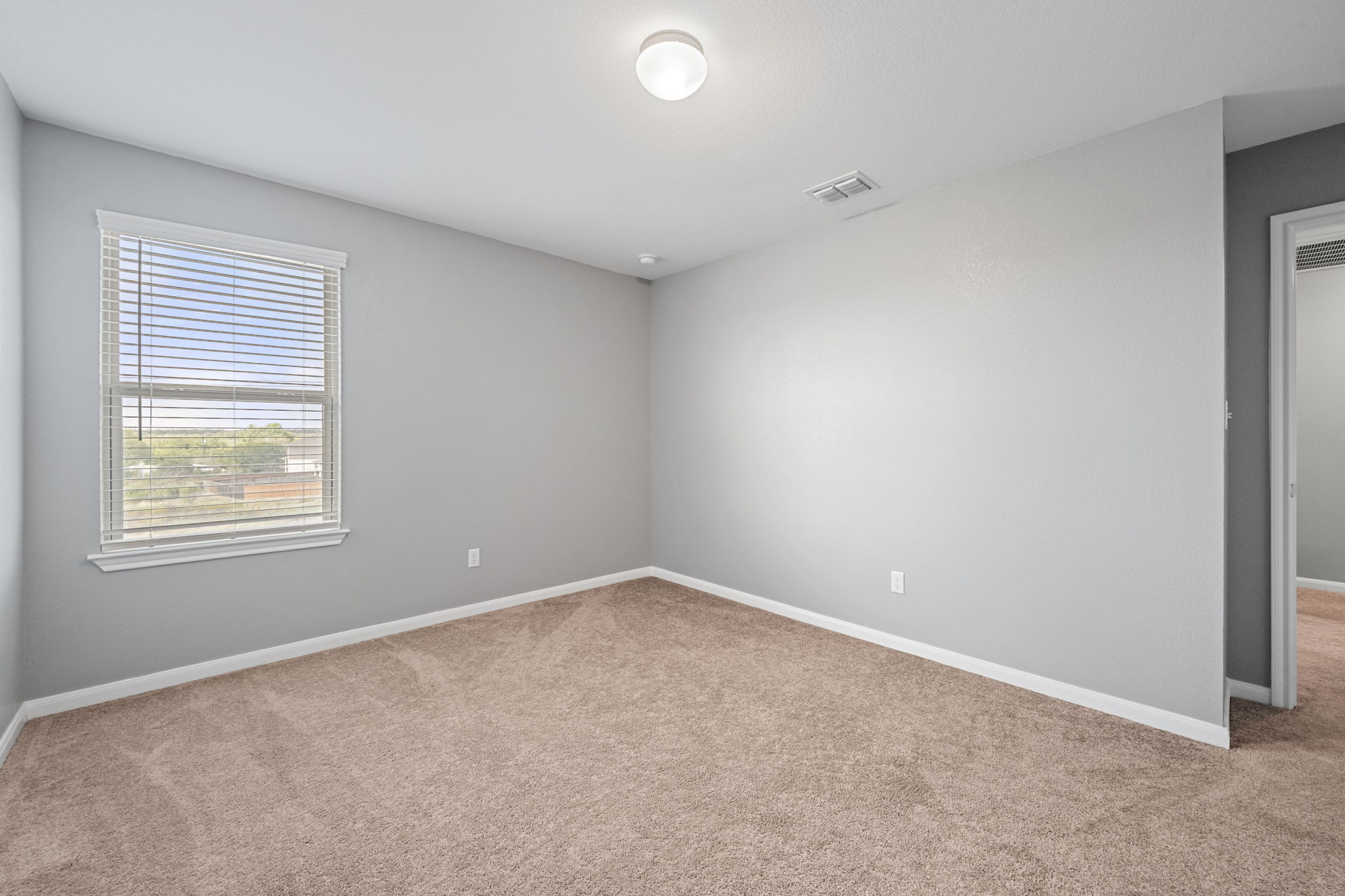 436 Spinnaker Loop Kyle, TX 78640 - Photo 6 of 14 an empty room with windows