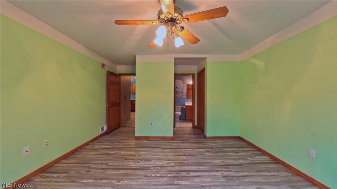 48276 Dyke Road Negley, OH 44441 - Photo 12 of 30 Unfurnished bedroom with dark wood finished floors, ensuite bath, and a ceiling fan