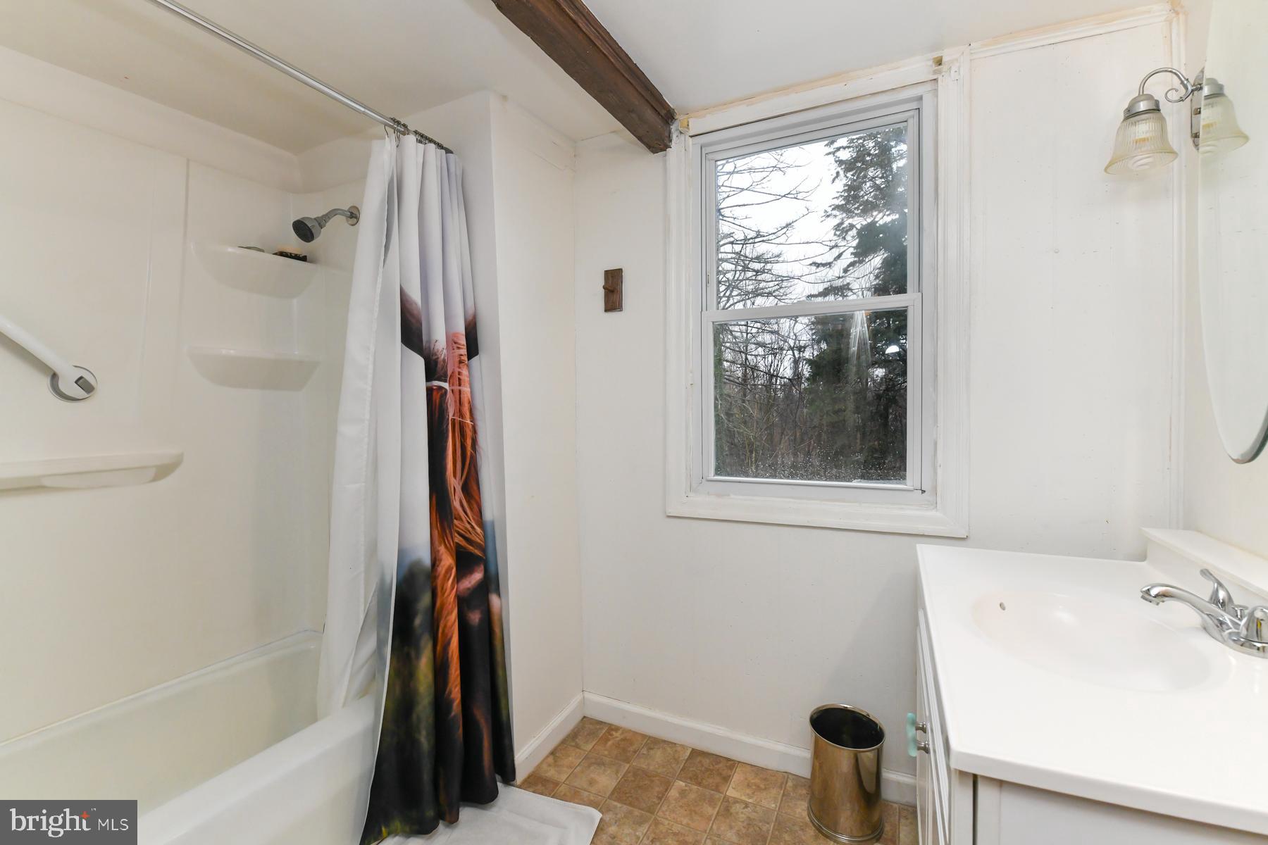 2270 Harding Highway Newfield, NJ 08344 - Photo 12 of 13 a bathroom with a tub and a window