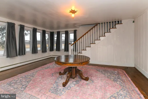 a view of a porch with a table and chairs
