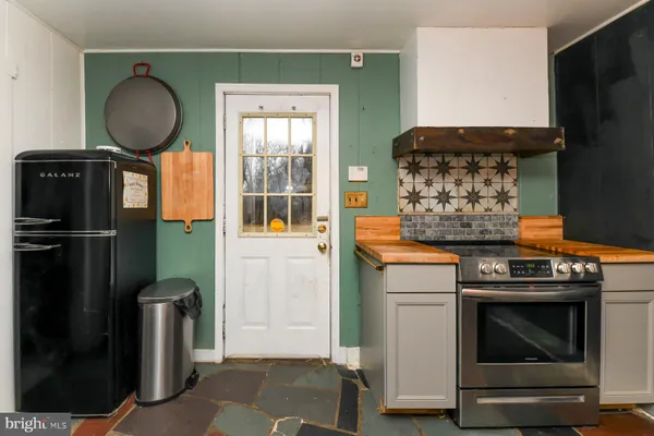 a kitchen with a stove and a mirror