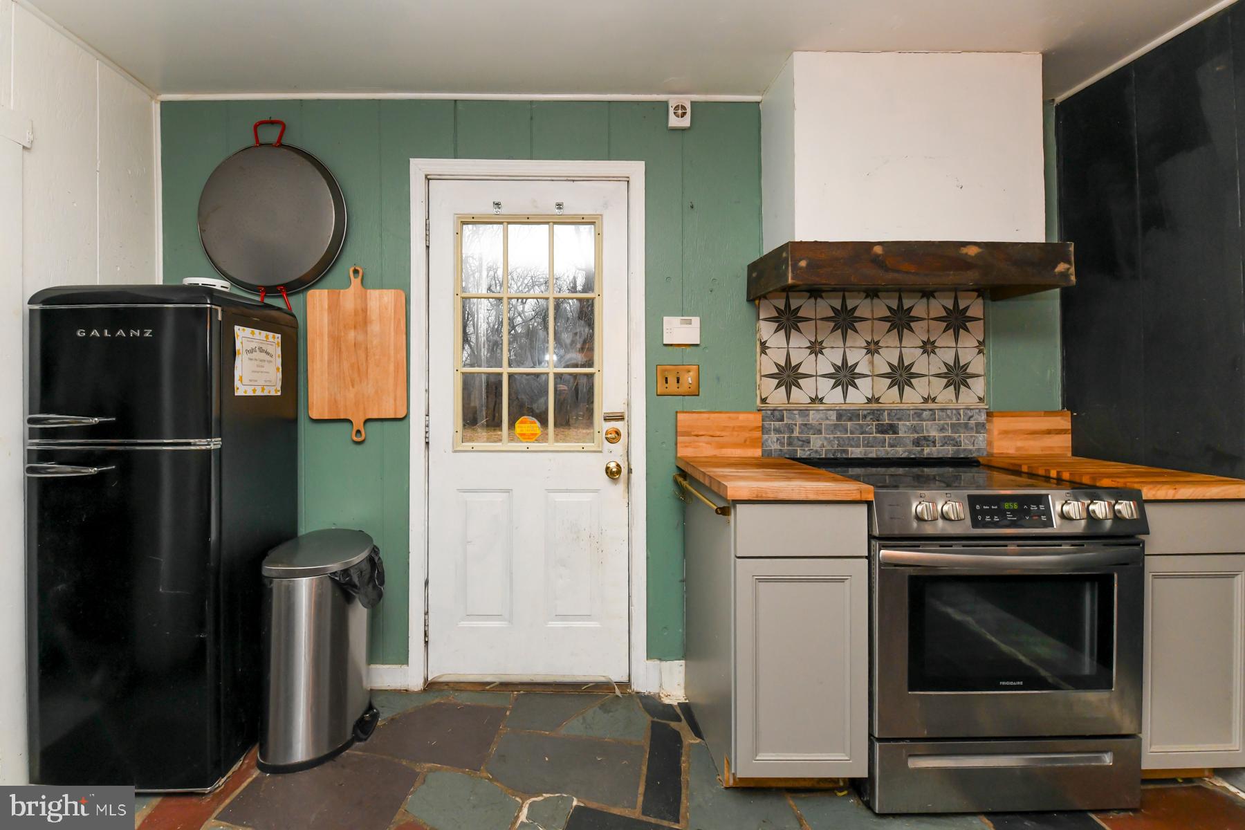 2270 Harding Highway Newfield, NJ 08344 - Photo 6 of 13 a kitchen with a stove and a mirror
