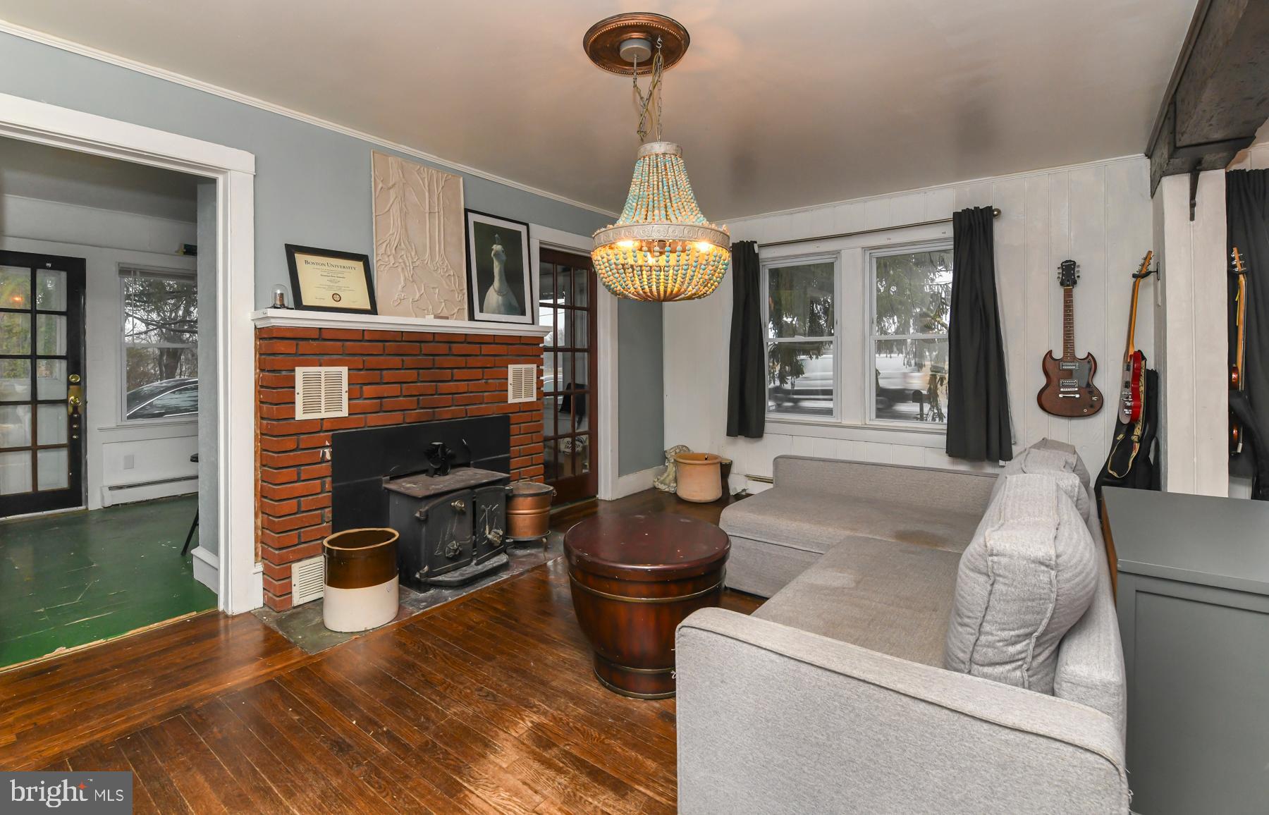 2270 Harding Highway Newfield, NJ 08344 - Photo 9 of 13 a living room with fireplace furniture and a chandelier