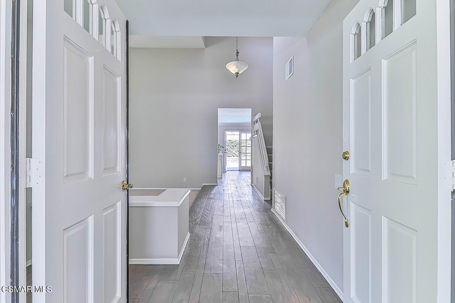 12523 Spring Creek Road Moorpark, CA 93021 - Photo 4 of 40 a view of a hallway with wooden floor and staircase