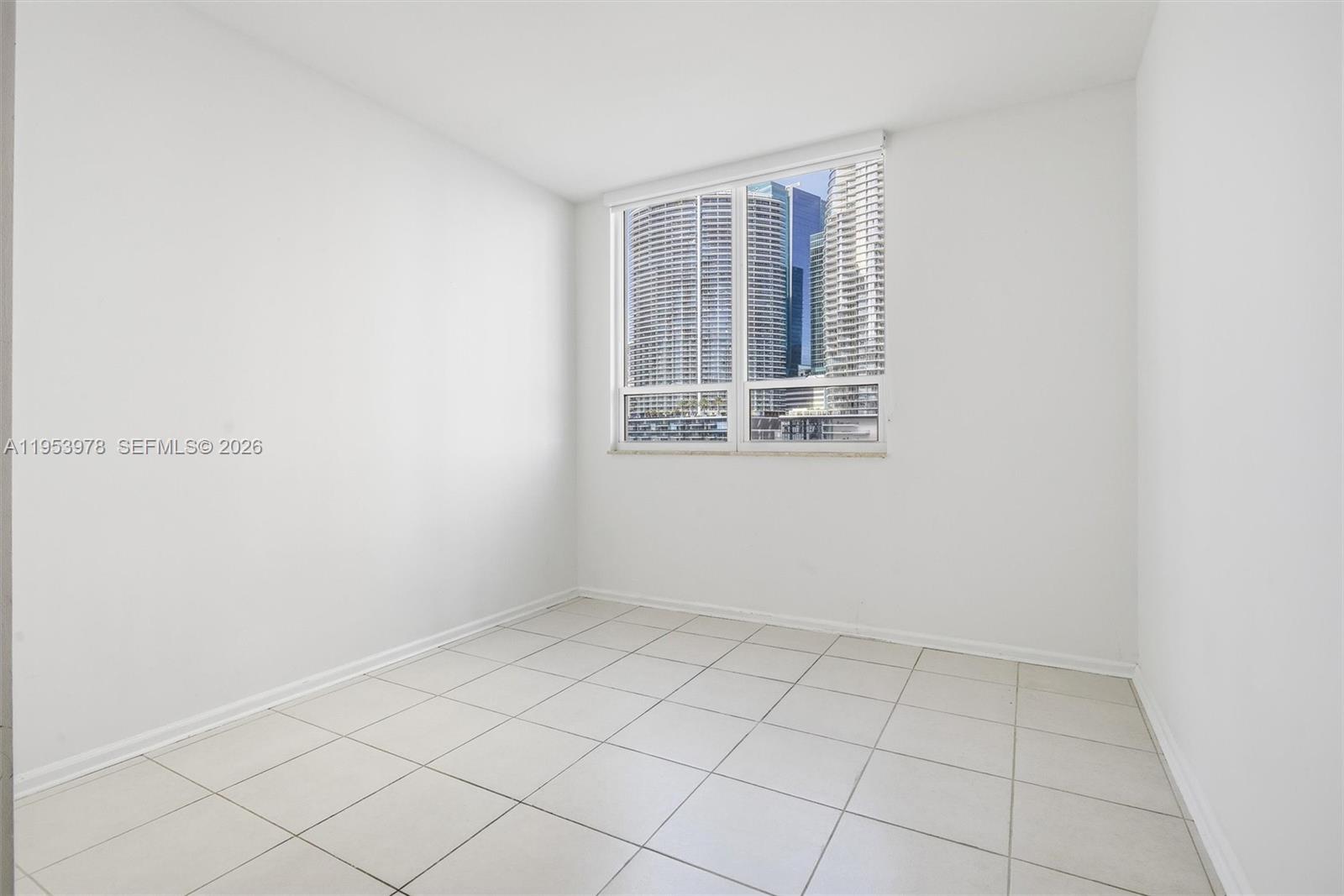 801 Brickell Key Boulevard, Unit 1404 Miami, FL 33131 - Photo 17 of 44 a view of an empty room with a window