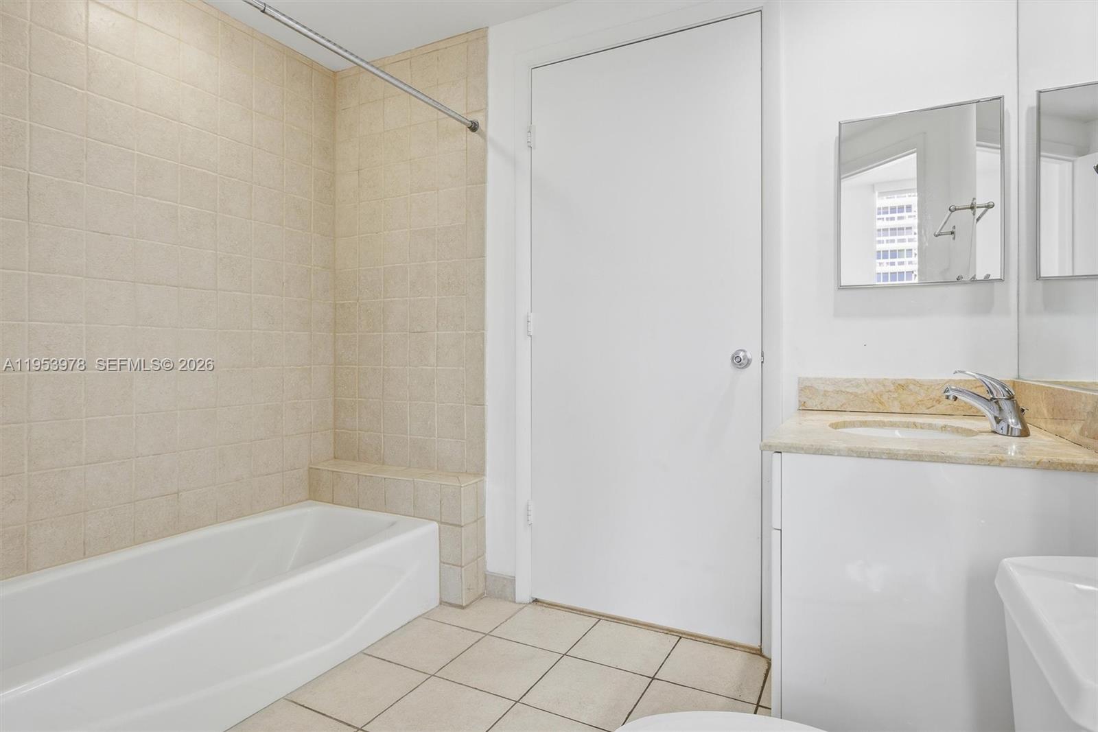 801 Brickell Key Boulevard, Unit 1404 Miami, FL 33131 - Photo 22 of 44 a bathroom with a bathtub and a sink
