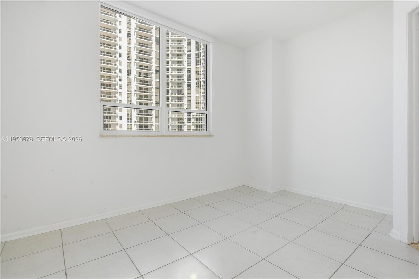 801 Brickell Key Boulevard, Unit 1404 Miami, FL 33131 - Photo 23 of 44 a view of an empty room with a window
