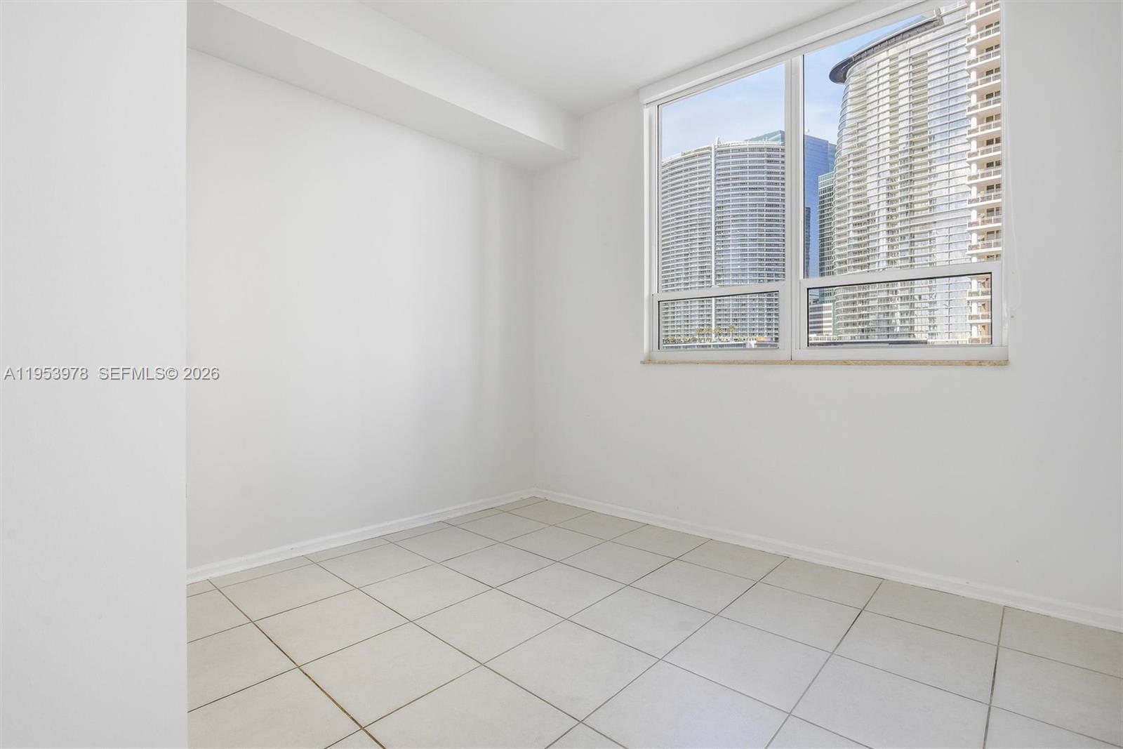 801 Brickell Key Boulevard, Unit 1404 Miami, FL 33131 - Photo 25 of 44 a view of an empty room with a window