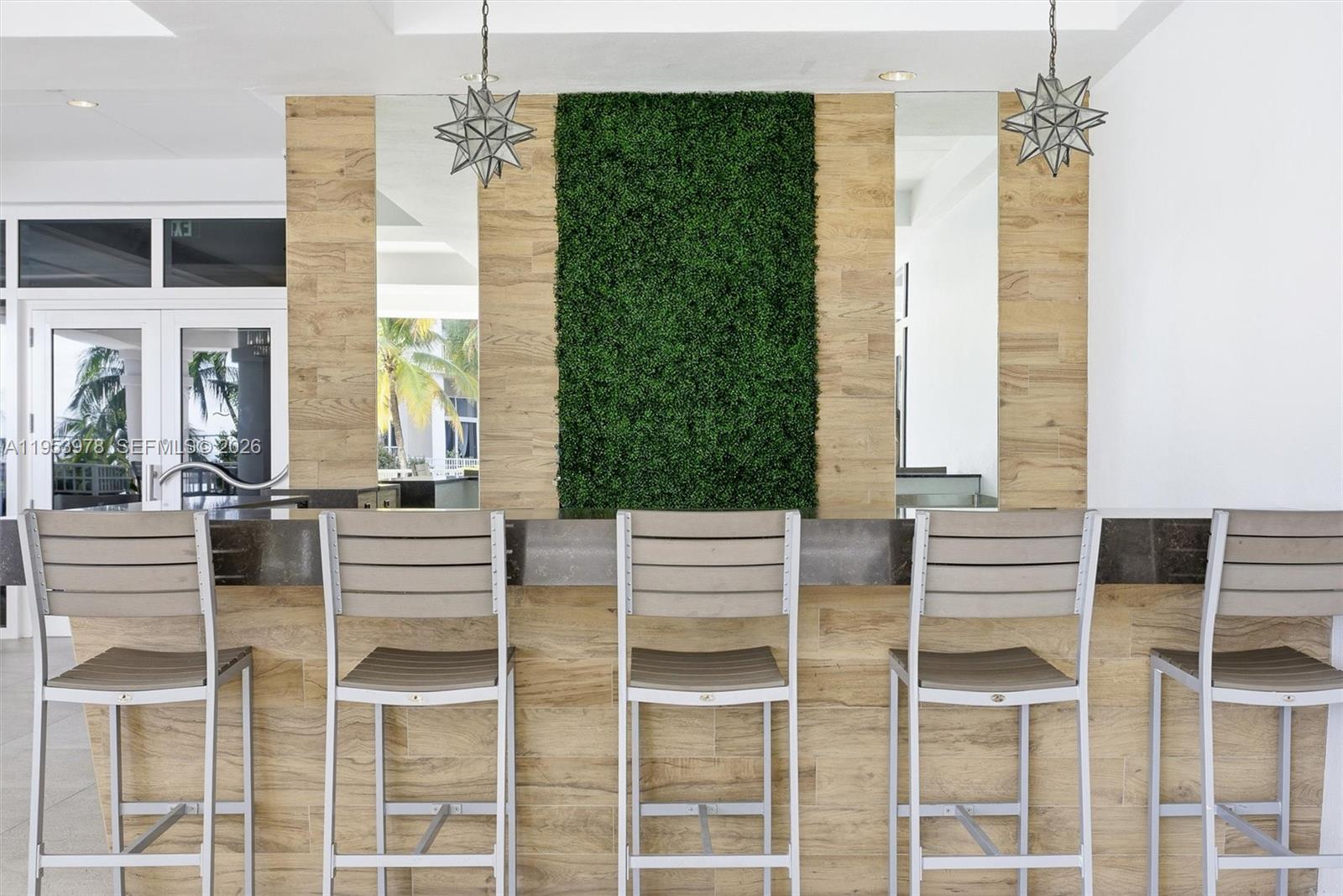 801 Brickell Key Boulevard, Unit 1404 Miami, FL 33131 - Photo 33 of 44 a view of a dining room with furniture large windows and wooden floor