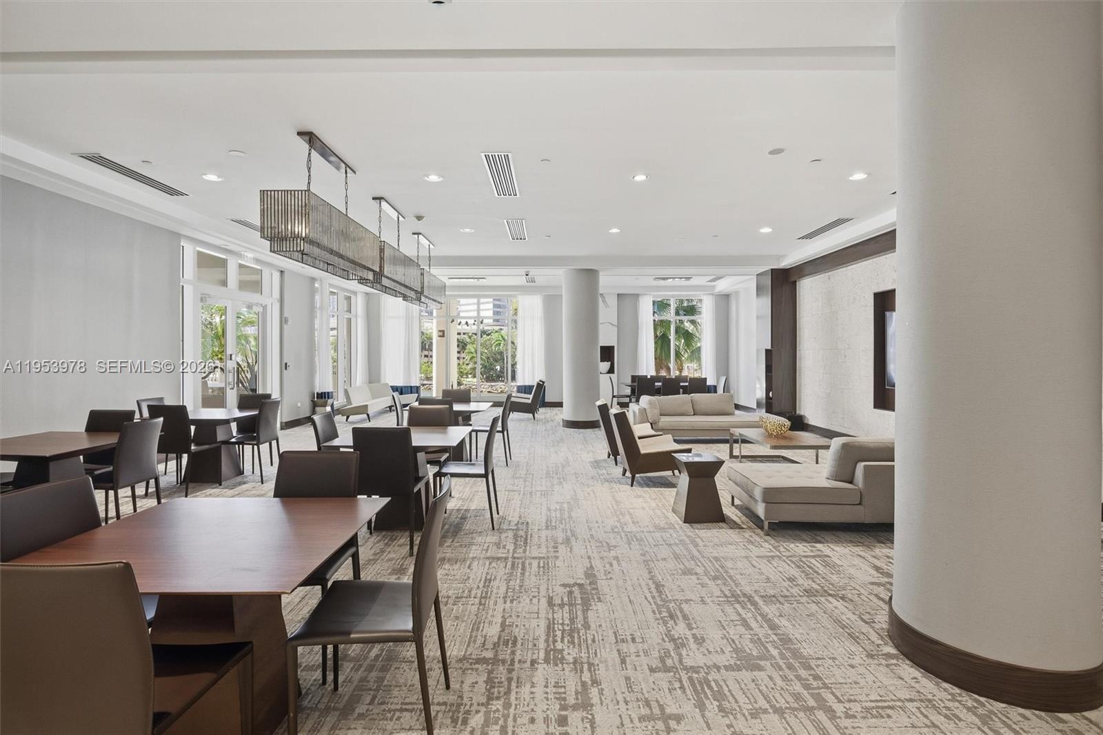 801 Brickell Key Boulevard, Unit 1404 Miami, FL 33131 - Photo 36 of 44 a living room with lots of furniture and a table