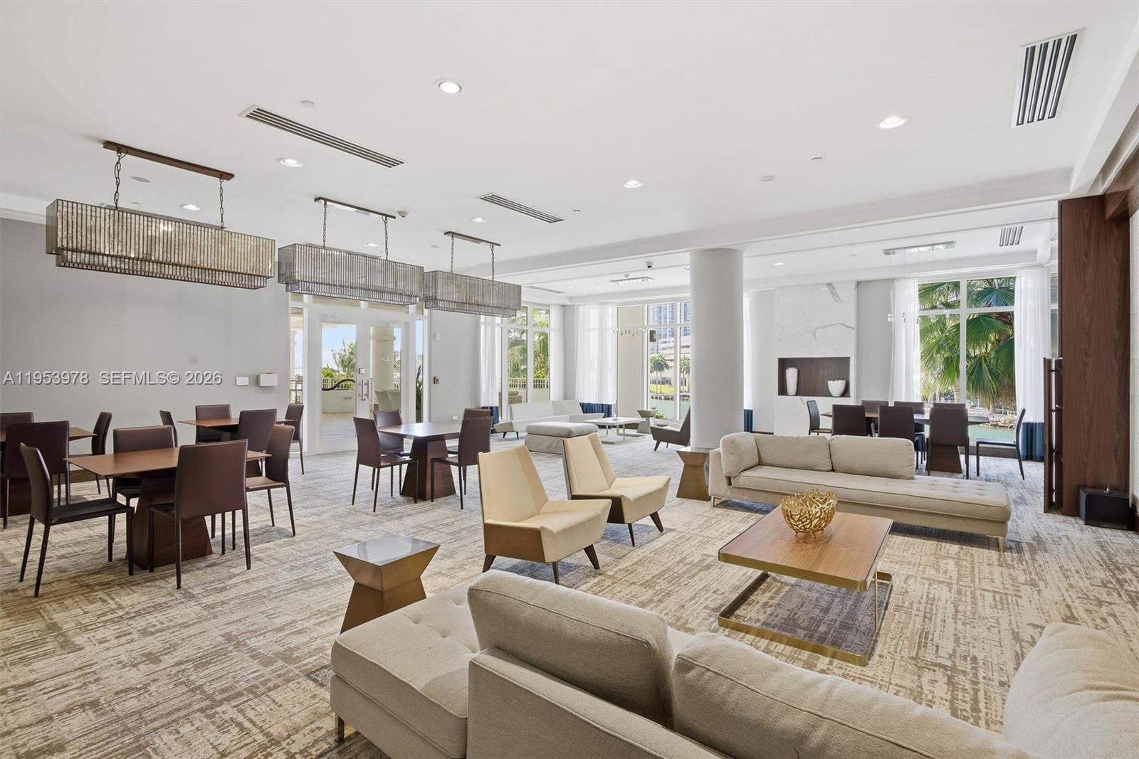 801 Brickell Key Boulevard, Unit 1404 Miami, FL 33131 - Photo 37 of 44 a living room with furniture and a large window