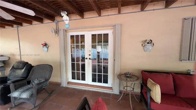 a view of a door and chair in the balcony