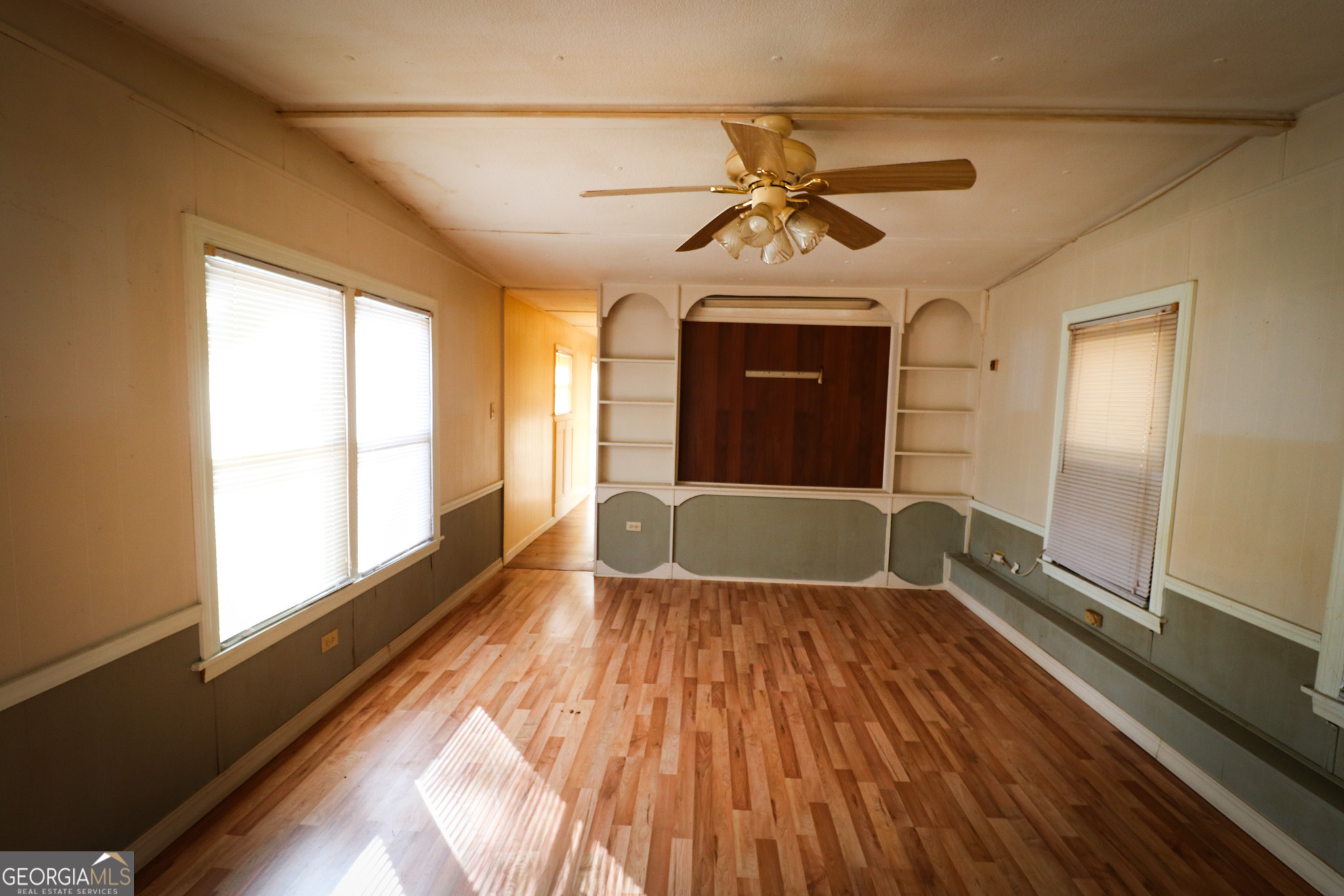2447 Williamson Road Williamson, GA 30292 - Photo 15 of 95 a view of a livingroom with wooden floor and a ceiling fan