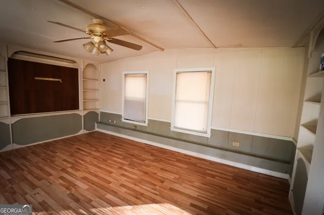a bathroom with a granite countertop bathtub shower sink mirror and toilet