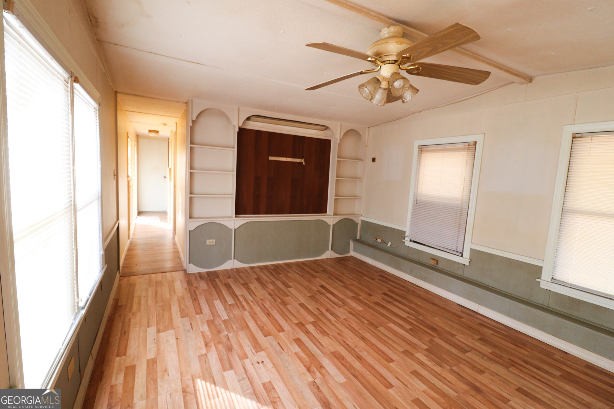 2447 Williamson Road Williamson, GA 30292 - Photo 17 of 95 a view of a livingroom with wooden floor and a ceiling fan