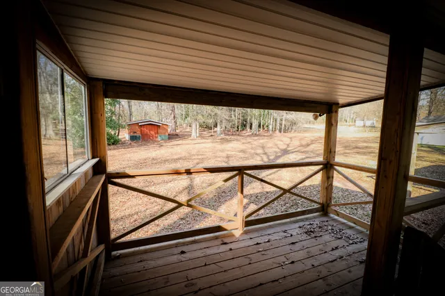 a view of dirt yard with a large tree