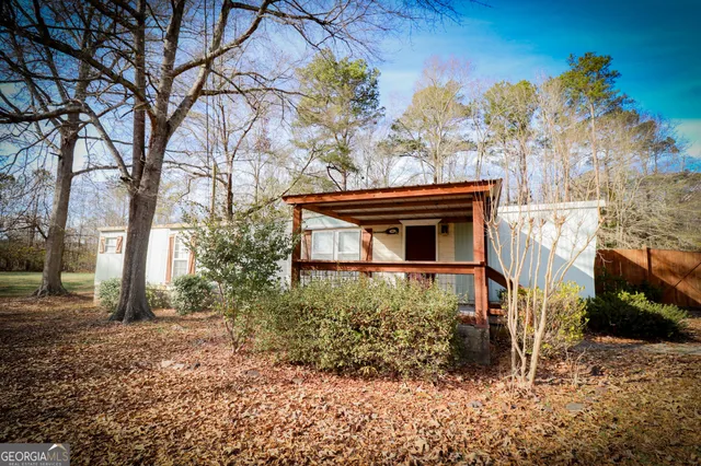 a view of a house with a snow in the yard
