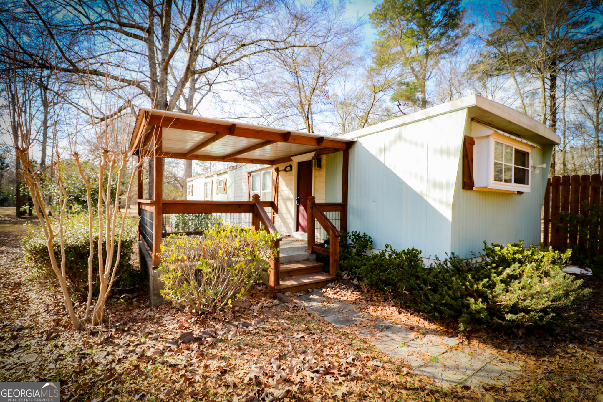 2447 Williamson Road Williamson, GA 30292 - Photo 45 of 95 a yellow house with a flower garden in front of it