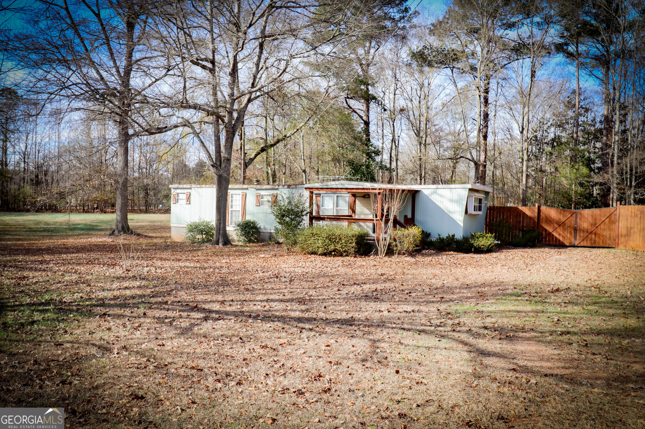 2447 Williamson Road Williamson, GA 30292 - Photo 72 of 95 a wooden bench sitting in middle of a field