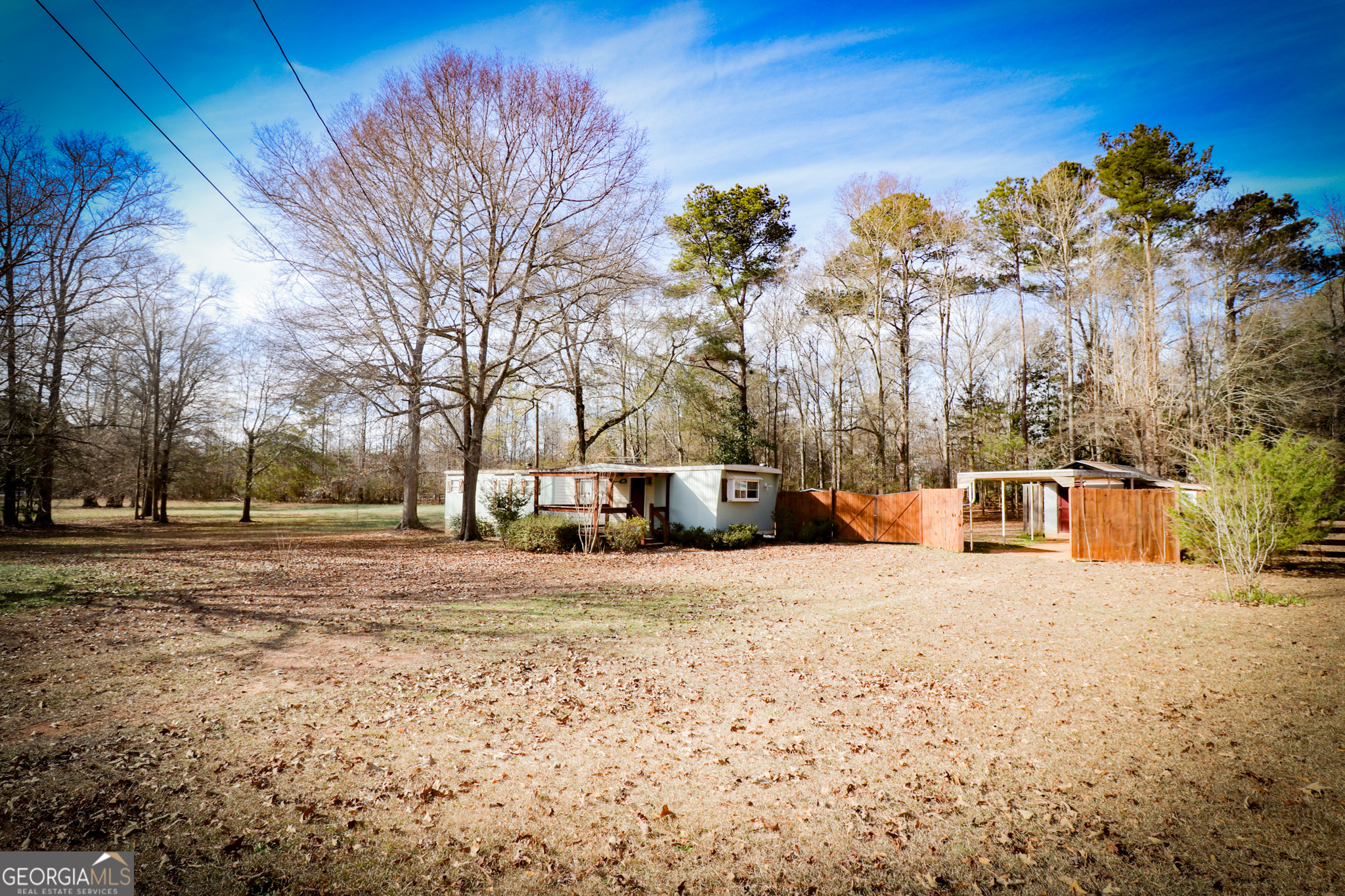 2447 Williamson Road Williamson, GA 30292 - Photo 82 of 95 a view of a white house with a yard