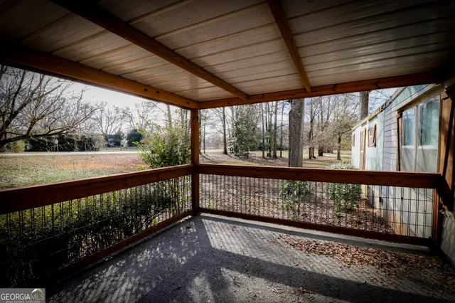 a view of a kitchen with wooden floor and electronic appliances