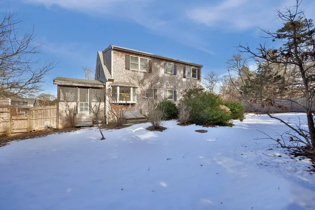 a view of a house with backyard and sitting area