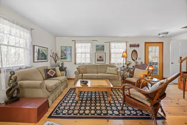 a living room with furniture rug and window