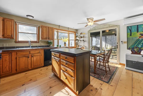 a kitchen with granite countertop a sink stove and cabinets