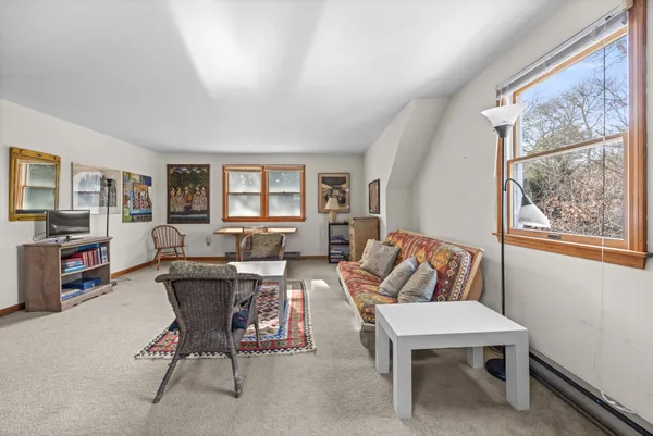 a view of a livingroom with furniture and a window