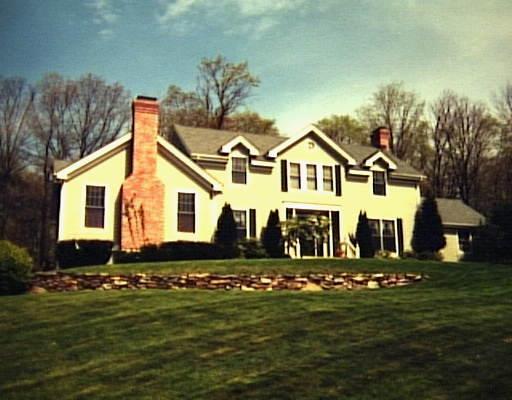 13 Farm Meadow Road Newtown, CT 06470 - Photo 1 of 1 a front view of a house with a garden