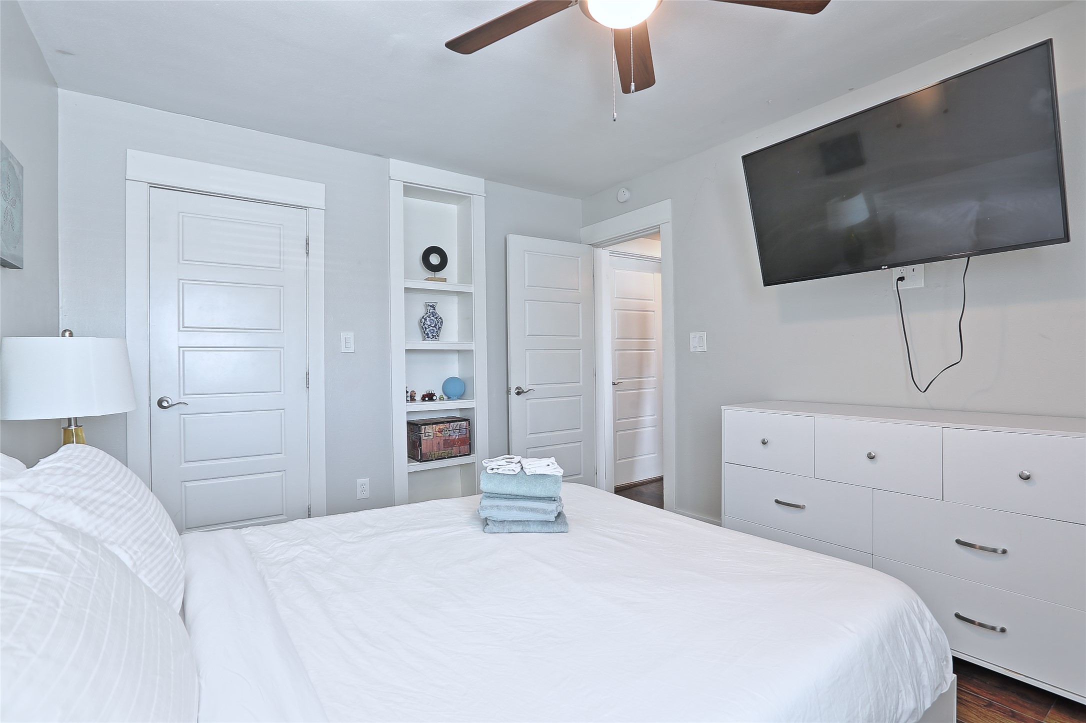 4804 West Wind Trail, Unit 101 Austin, TX 78745 - Photo 19 of 24 a bedroom with a bed a dresser and flat screen tv